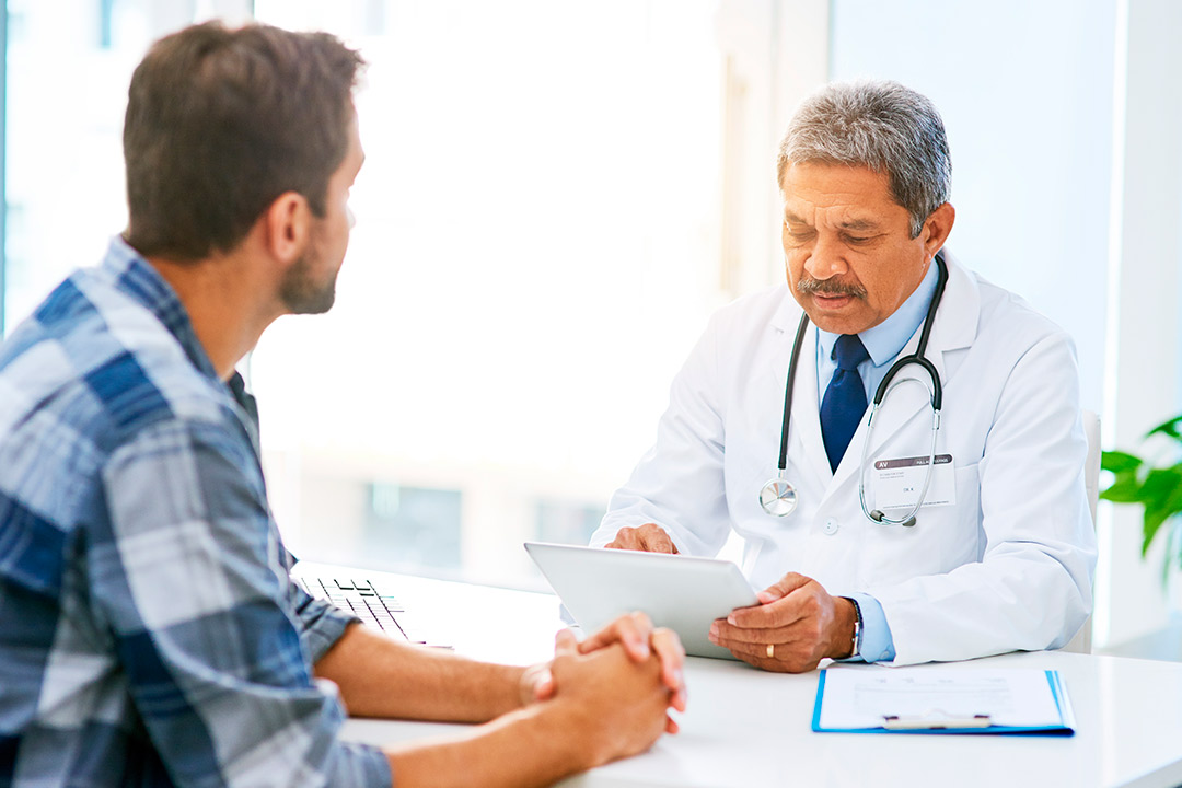 A doctor engages in a conversation with a patient regarding men's health topics.
