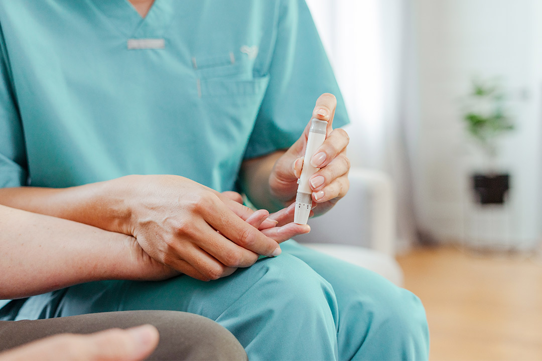 A nurse measures a patient's temperature with a thermometer, emphasizing the importance of skilled nursing in chronic care.